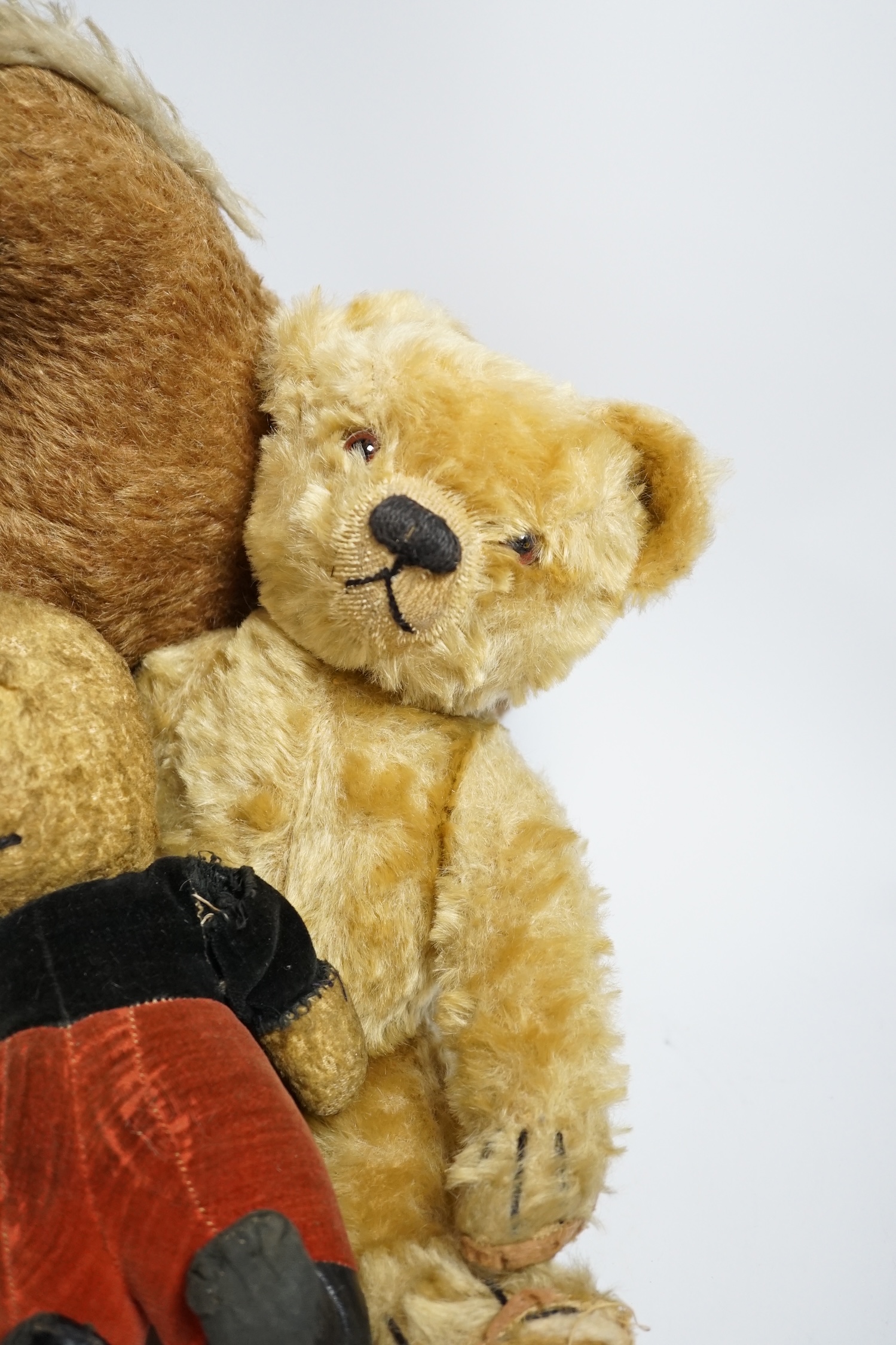 A Chad Valley teddy bear, 34cm high, a smaller bear in velvet clothes and a Merrythought horse